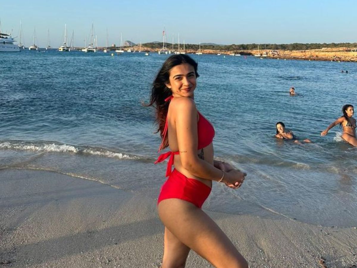 Apoorva seductive pose on the beach in red bikini - Photo Gallery